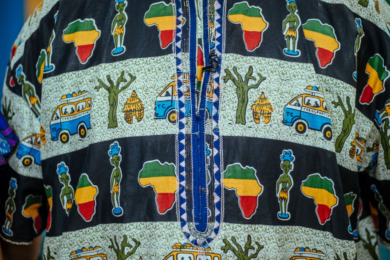 Close-up of vibrant African patterned fabric featuring cultural symbols and colorful designs.