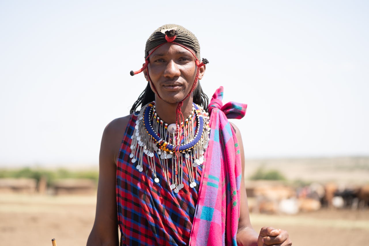 our-story Portrait of Masai tribe member in traditional attire, showcasing cultural heritage in Kenya.